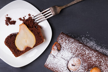 Delicious chocolate cake with pear slice served on a white plate