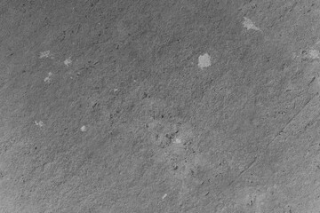 Textured surface showing patterns and markings in grayscale