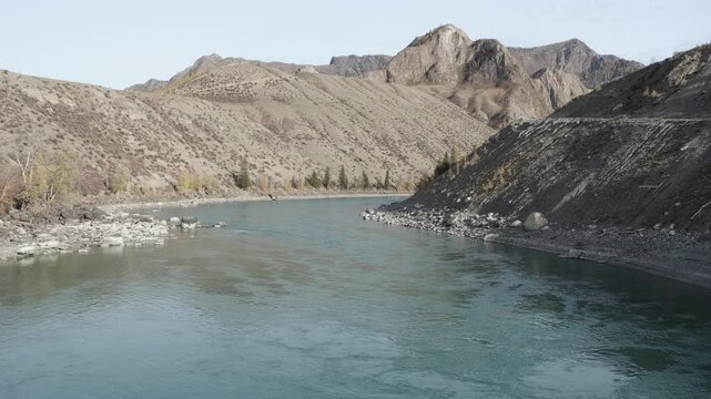 Calm flow of water in the river. Altai mountain landscape in autumn