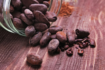 Cocoa beans scattered from glass jar