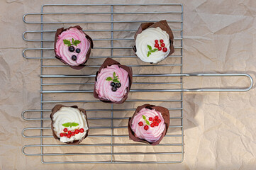 Freshly Baked Cupcakes with Berry Toppings on Cooling Rack