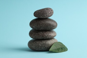 Stack of rocks on light blue background. Harmony and life balance