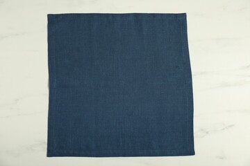 Dark blue napkin on white marble table, top view
