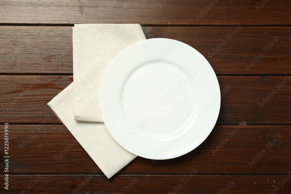 Poster Light napkin and empty plate on wooden table, top view