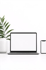 Laptop and smartphone displaying blank screen on white desk with plant