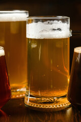 Variety of beer glasses with different types of beer on wooden table. Close-up.