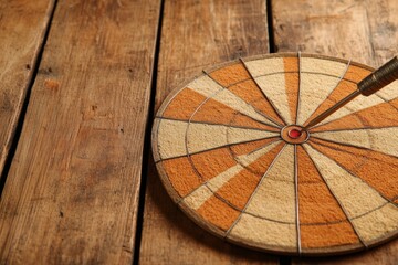 darts, throwing darts. The yellow arrow hits the target. The target is a circle with a red dot in the center. victory, success, hitting the target