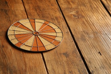 darts, throwing darts. The yellow arrow hits the target. The target is a circle with a red dot in the center. victory, success, hitting the target