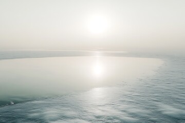 Fototapeta premium A peaceful morning on a frozen lake, with thin ice reflecting the pale winter sun.