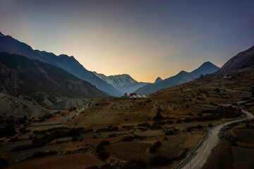 Sunset view of the Himalaya mountains in Manang village. Tilicho peak, a route to Khangsar village and Manang Basecamp hotel after sunset.