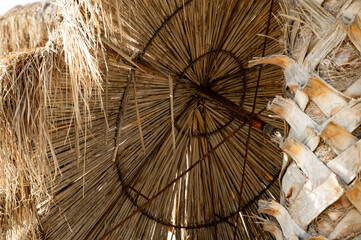Straw umbrella view from the inside. Iron frame inside the umbrella.