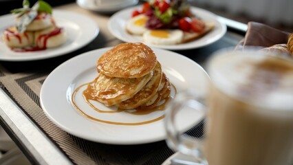Icing sugar falling on pancakes for breakfast