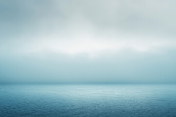 Obraz premium Serene ocean view under a misty sky, showcasing calm waters and a tranquil atmosphere
