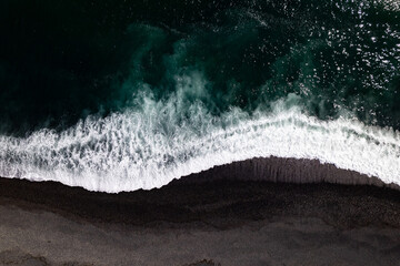 Aerial drone view of epic ocean waves crashing on the shoreline black beach Reynisfjara in Iceland in VIK Myrdal in Golden Circle Area