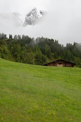 Rustic Alpine Cabin with Misty Mountain Peaks in the Austrian Alps