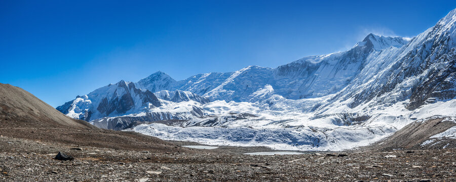 Panoramic view of the snow covered Himalaya mountains near Tilicho lake. Himalaya highlands in late autumn sunny day. Annapurna circuit trek, Nepal.