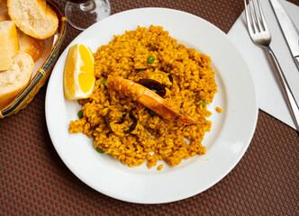 Just cooked paella de marisco served on table in restaurant.