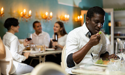 Lonely restaurant visitor enjoying his vegetarian meal at dinner