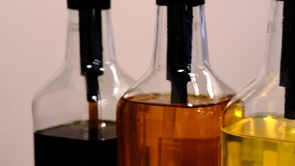 Colorful syrups in glass bottles captured close up with vibrant lighting highlighting the variety of shades and textures perfect for beverages desserts and culinary creations offering a visual treat