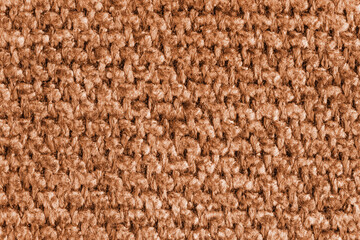 Texture of orange jacquard fabric, close up of rough weave macro. Material for home textile, upholstery and curtain decor, garment. Background, wallpaper, backdrop.