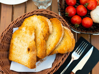 Kitchen table with cooking tools and fresh vegetables. Pan Con tomate, bread with tomato and garlic. Catalonian cuisine