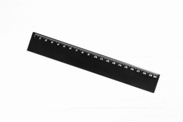 Fototapeta premium One black ruler on white table, top view
