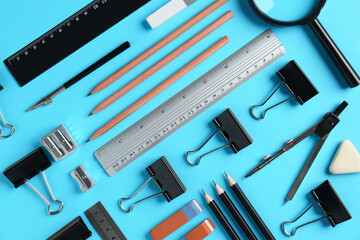 Flat lay composition with ruler and other stationery on light blue background