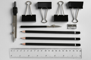 Flat lay composition with ruler and other stationery on light grey background
