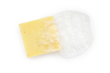 Yellow soap with foam on white background, top view