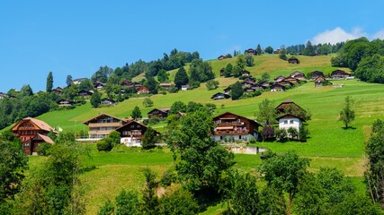 Explore the charm of a traditional Swiss village in Switzerland, with rustic houses set against the...