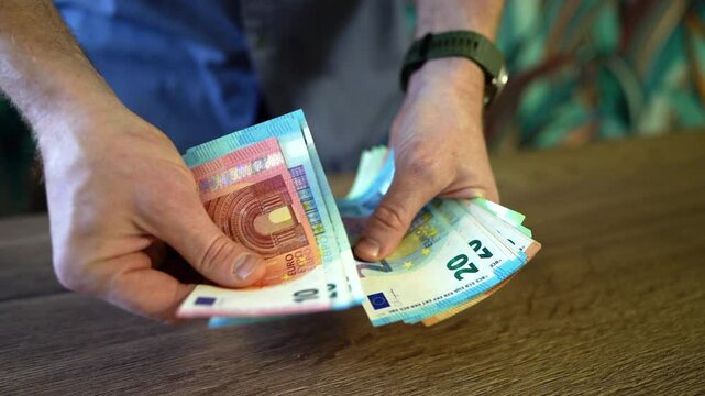 Counting EURO coins notes. EURO Money cash in hand. EURO bills and coins of European Union. Male hands counting Coins. 100 EURO Money Banknotes for pay. Hands counting money pack of hundred bills. 