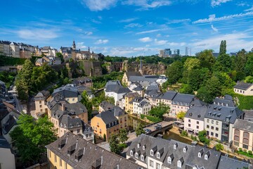 A breathtaking panoramic cityscape view of Luxembourg City, Luxembourg, highlighting its historic architecture, scenic parks, and the stunning natural countryside surrounding the city.