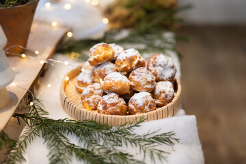Delicious holiday treats in basket with festive greenery
