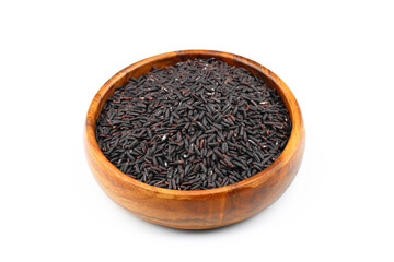 pile of black rice in a wooden bowl isolated on a white background.