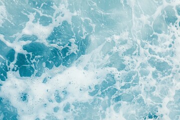 Fototapeta premium Gentle waves rolling across a turquoise ocean surface, creating white foam and offering a calming, peaceful backdrop that evokes tranquility and serenity in nature