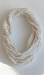 Obraz premium Twisted pearl necklace on white background; elegant jewelry photography for online store