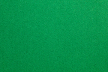 A green background with a green grassy texture, textured origami paper backdrop