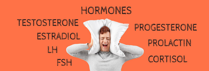 Handsome emotional man in stylish pajamas with pillow screaming on orange background