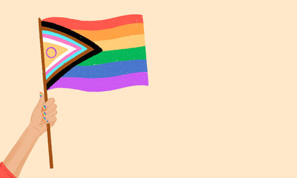 Hand holding inclusive pride flag symbolizing diversity