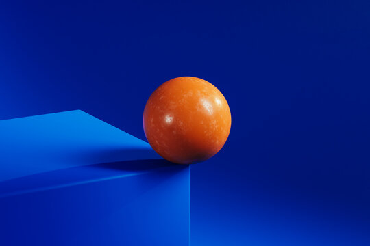 Orange sphere on blue shapes in abstract design