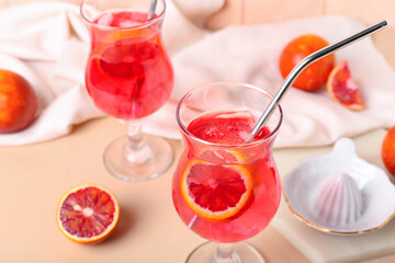 Glass of tasty blood orange lemonade on table, closeup