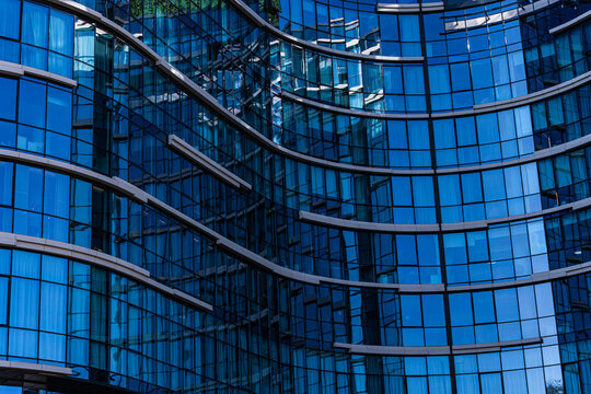 Curved glass facade of modern building in daylight