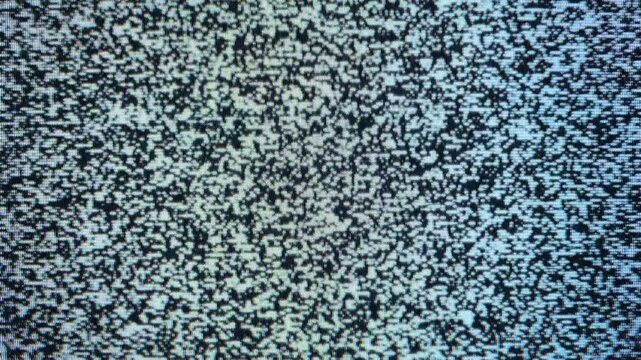 Close-up view of static noise on an old television screen.