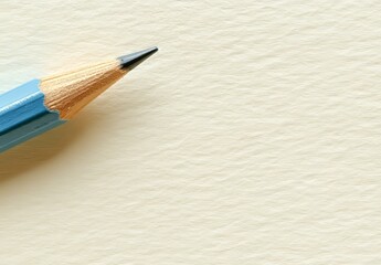 Obraz premium A blue pencil, representing readiness and fresh starts, stands alone on a white backdrop