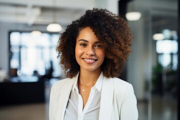 Fototapeta premium Portrait of a smiling young African American businesswoman in modern office