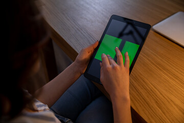 A person enjoys using a tablet at home, making multitasking productive and efficient