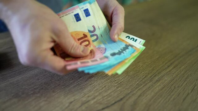 Counting EURO coins notes. EURO Money cash in hand. EURO bills and coins of European Union. Male hands counting Coins. 100 EURO Money Banknotes for pay. Hands counting money pack of hundred bills. 