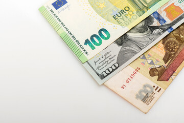 Different money in 100 euro, 100 dollar and Russian 100 ruble banknotes as background. Top view.