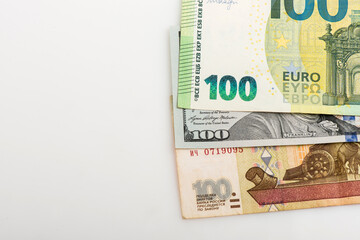 Different money in 100 euro, 100 dollar and Russian 100 ruble banknotes as background. Top view.