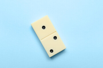 White domino block on blue background